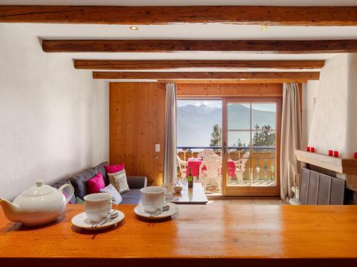 a living room with a table with tea cups on it at Apartment Résidence Le Chalet 5 by Interhome in Crans-Montana
