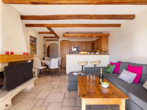 a living room with a couch and a table at Apartment Résidence Le Chalet 5 by Interhome in Crans-Montana