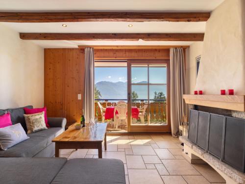 a living room with a couch and a table at Apartment Résidence Le Chalet 5 by Interhome in Crans-Montana
