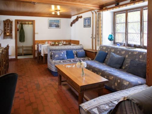 een woonkamer met een bank en een tafel bij Holiday Home Villa Roduit by Interhome in Le Châble