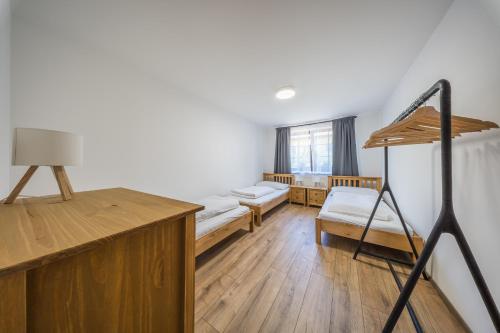 a room with two bunk beds and a ladder at Chalupa Pod Starú horú in Bohuslavice