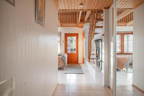 a hallway of a house with an orange door at Koda Halo Lodge - Sauna, Parking & Playstation in Rovaniemi