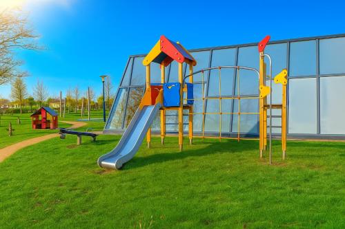 a playground with a slide in a park at Premium-Strand Chalet an der Nordsee - Noordzee - Zeeland in Breskens