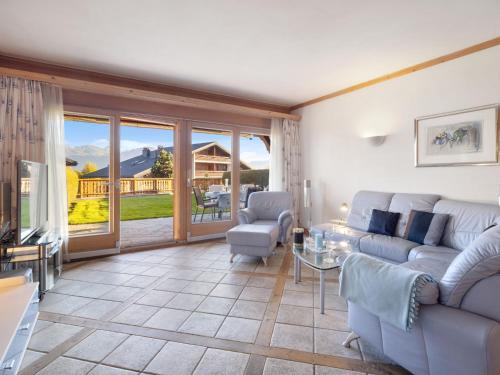 a living room with a couch and a table at Apartment Antares R05 by Interhome in Crans-Montana