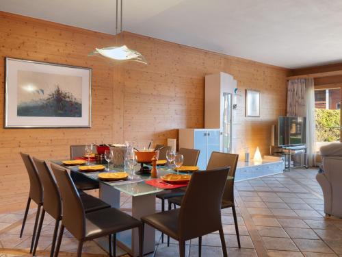 a dining room and kitchen with a table and chairs at Apartment Antares R05 by Interhome in Crans-Montana
