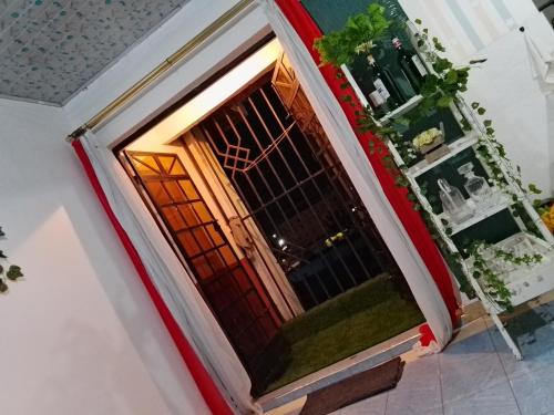 an open door of a house with plants at Lovely one bedroom airbb in THIKA with WiFi ,ample parking-next to the road in Thika