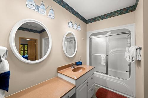 a bathroom with a sink and a shower and a mirror at Dreamcatcher CV By Colonial Properties in Gatlinburg