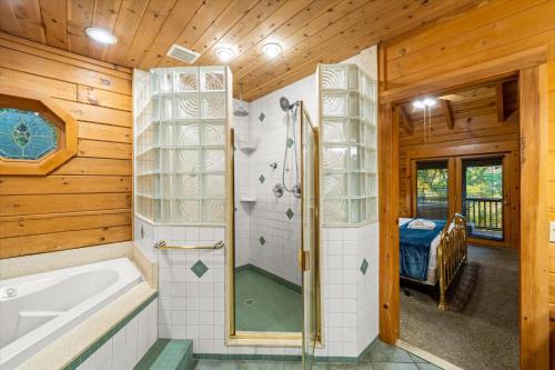 a bathroom with a shower and a bath tub at Dreamcatcher CV By Colonial Properties in Gatlinburg