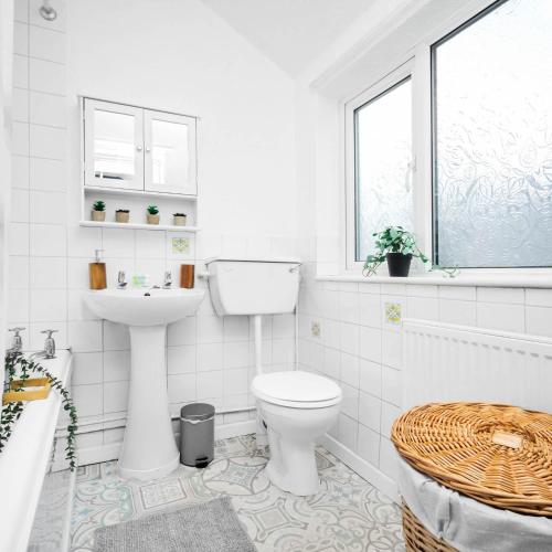a white bathroom with a toilet and a sink at Stylish Three Bed House - Parking - Garden - Netflix 17ML in Birmingham