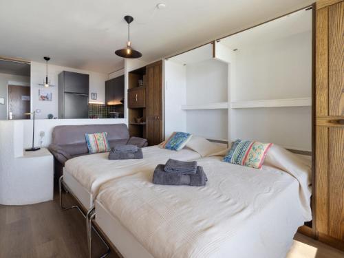 a bedroom with two beds with towels on them at Studio Jeanne D'Arc Apt- A-8 by Interhome in Crans-Montana