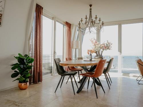 a dining room with a table and chairs at Apartment De Zeeparel by Interhome in Egmond aan Zee
