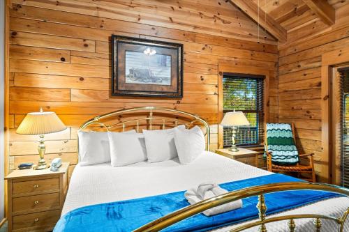 a bedroom with a bed in a room with wooden walls at Dreamcatcher CV By Colonial Properties in Gatlinburg