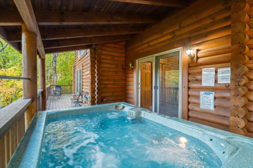 a hot tub on the porch of a log cabin at Dreamcatcher CV By Colonial Properties in Gatlinburg