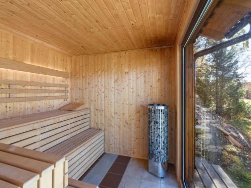 a wooden sauna with a large window in it at Holiday Home Kralovice by Interhome in Nebahovy