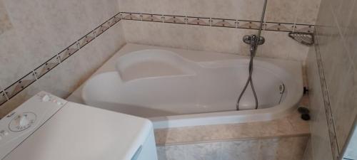 a bathroom with a bath tub with a shower at Apartmán Líška v Tatranskej Štrbe in Tatranska Strba