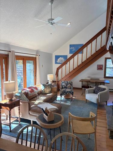 a living room with a couch and a staircase at The Magic Teacup in Davis