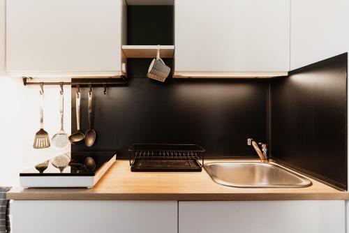 a kitchen with a sink and a counter top at Hike & Ski-in Ski-out Mountain View Apartment for Family & Friends in Hinterstoder