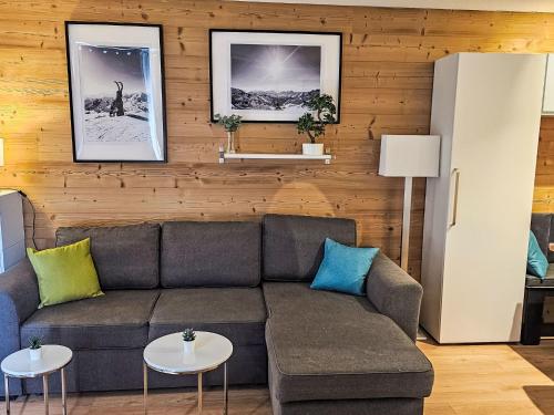 a living room with a couch and two tables at Apartment Nazca I6 by Interhome in Val Thorens