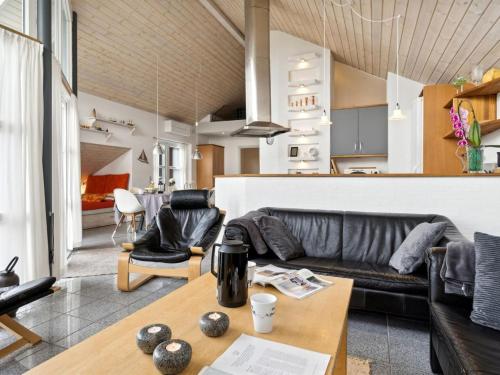 a living room with a couch and a table at Holiday Home Thrugels - 600m from the sea by Interhome in Hadsund