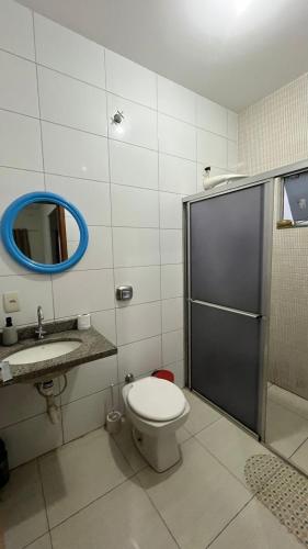 a bathroom with a toilet and a sink and a mirror at Apartment Poncho Verde - Primavera do Leste, Mato Grosso in Primavera do Leste