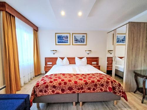 a bedroom with a large bed with a red blanket at Holiday Home Gästehaus Beretta by Interhome in Achenkirch