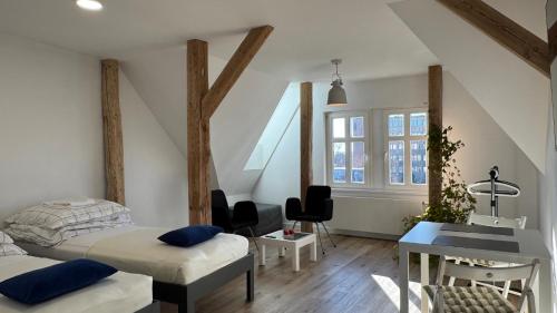 a bedroom with a bed and a desk and a staircase at OPOLSKA WENECJA-apartament typu STUDIO z tarasem in Opole