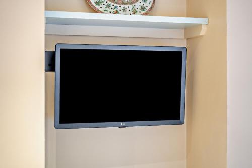 a flat screen tv hanging on a wall at Cub Bedroom Three in Eastdean