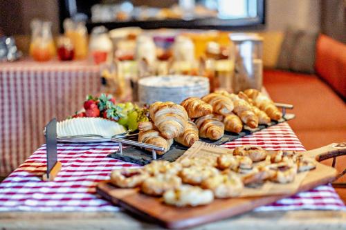 a table with bread and pastries on a table at Cub Bedroom Three in Eastdean