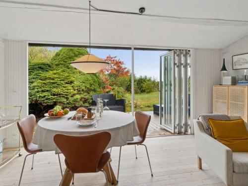 a kitchen and dining room with a table and chairs at Holiday Home Gun - 300m to the fjord by Interhome in Glostrup