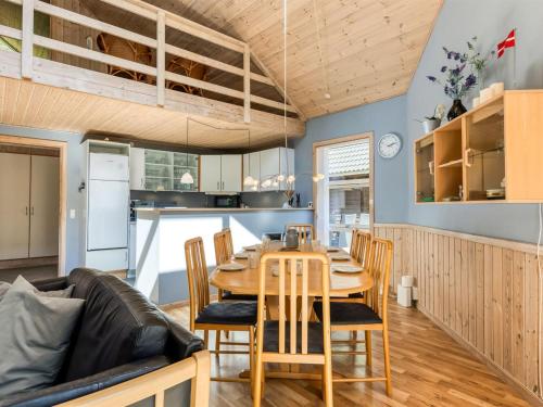 a kitchen and dining room with a wooden table and chairs at Holiday Home Hristijan - 4-8km from the sea by Interhome in Læsø