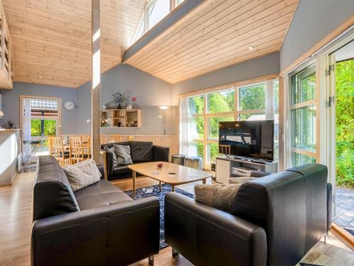 a living room with couches and a tv and a table at Holiday Home Hristijan - 4-8km from the sea by Interhome in Læsø