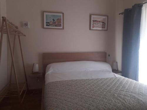 a bedroom with a bed with a white comforter at Casas da Lameirancha in Mação