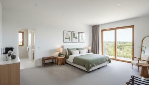 een witte slaapkamer met een bed en een balkon bij Circle Edge Cabana in Kandy