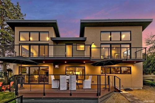 a house with a deck with chairs and umbrellas at 2030 Marconi Way home in South Lake Tahoe