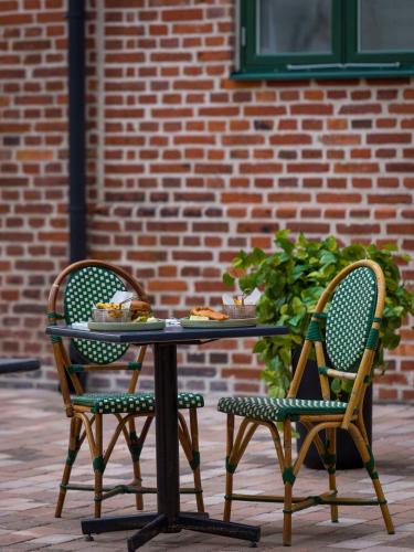 a table and two chairs with food on it at Hotel Bishops Arms Lund in Lund