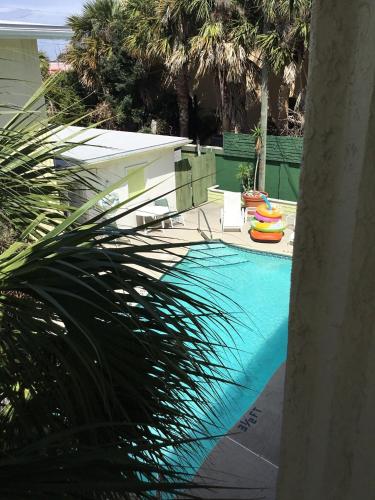 a swimming pool with a slide and a swimming pool at Tropical Beach Studio Getaway B in Cocoa Beach