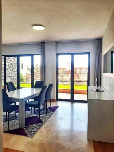a kitchen and dining room with a table and chairs at Private Garden and Pool in the Heart of Funchal in Funchal