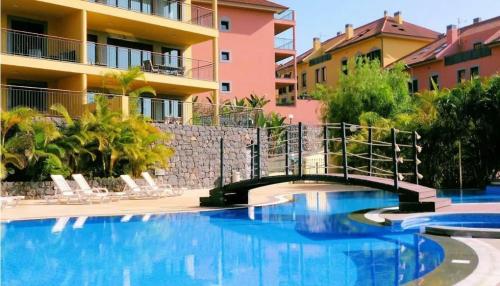 a bridge over a swimming pool in front of a building at Private Garden and Pool in the Heart of Funchal in Funchal