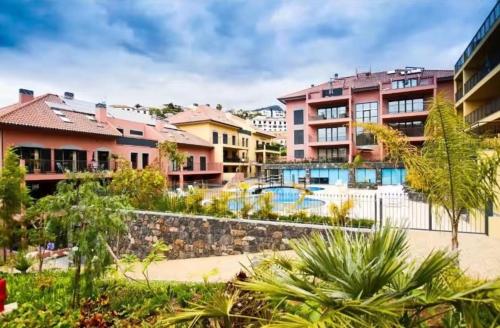 a resort with a pool and some buildings at Private Garden and Pool in the Heart of Funchal in Funchal