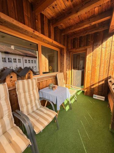 a room with a table and chairs in a cabin at Chic lodge-apartments in Ehrwald