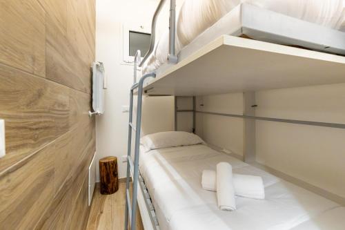 a white bunk bed in a small room at Hostdomus - Valle Studio in Grange Sises