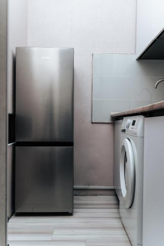 eine Küche mit Kühlschrank und Waschmaschine in der Unterkunft Testimiteanu Two in Chişinău