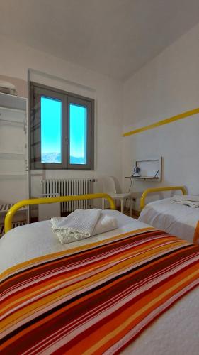 Postel nebo postele na pokoji v ubytování lassù minihotel