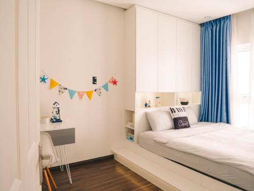 a small bedroom with a bed and a desk at 2BR Luxury riverview - Melody of the Sea Monarchy in Da Nang