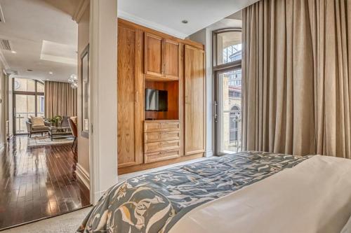 a bedroom with a bed and a tv and a window at Micheal Angelo towers in Johannesburg