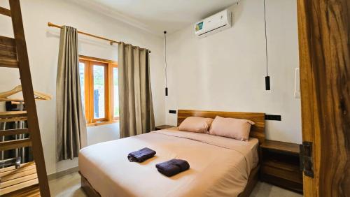 a bedroom with a bed with two pillows on it at HomeVillas in Kuta Lombok