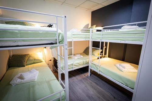 a room with two bunk beds and twounks at CyberHostel Almada in Almada