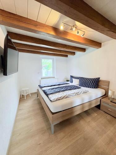 a bedroom with a large bed in a room at Ferienhaus Lisbeth in Edesheim