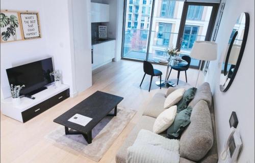 a living room with a couch and a table at 1 Bedroom apartment near Canning Town in London