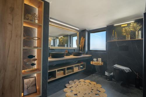 a bathroom with two sinks and a large mirror at Petra Luxury Villa in Heraklio Town